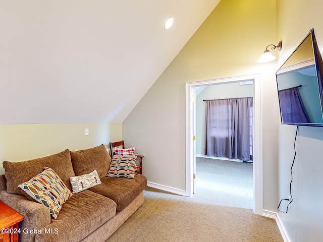 carpeted living room featuring lofted ceiling