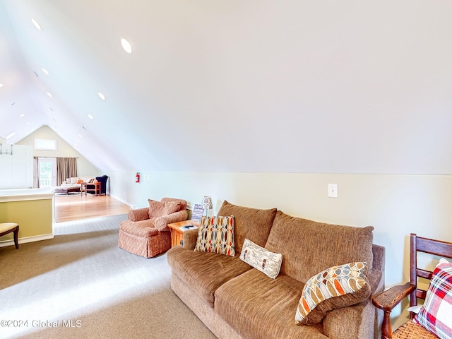 carpeted living room with lofted ceiling