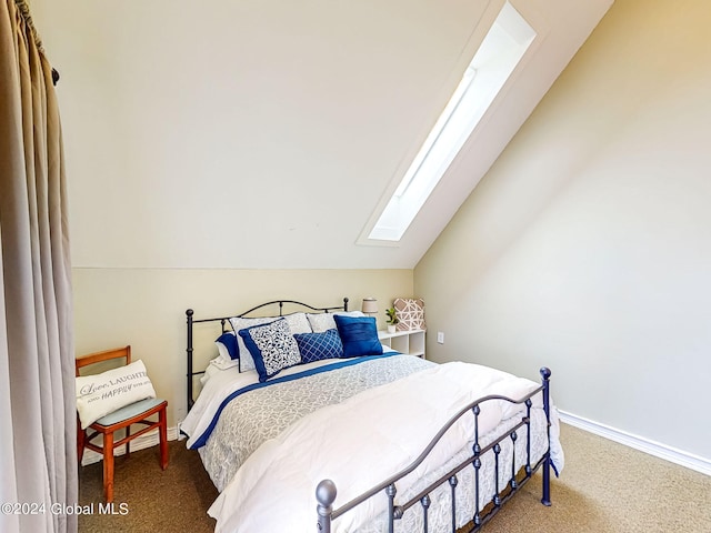 carpeted bedroom featuring lofted ceiling with skylight