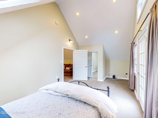 carpeted bedroom with high vaulted ceiling