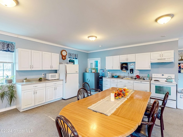 kitchen with sink, ornamental molding, white appliances, and white cabinetry