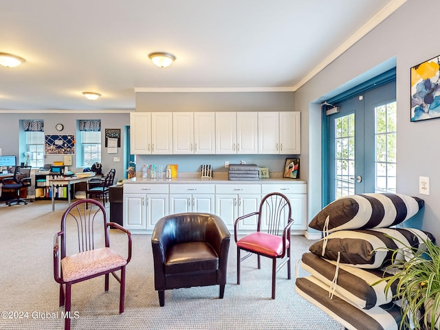 kitchen with ornamental molding, light carpet, french doors, and white cabinets