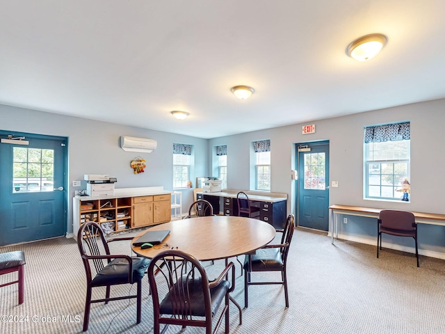 dining space featuring light carpet, plenty of natural light, and a wall mounted AC