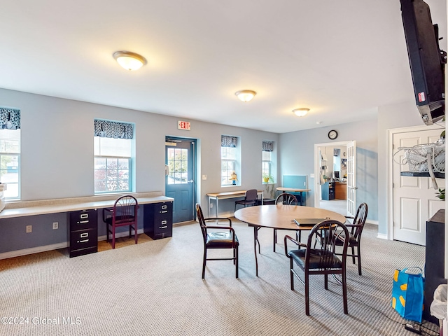 carpeted dining space with built in desk