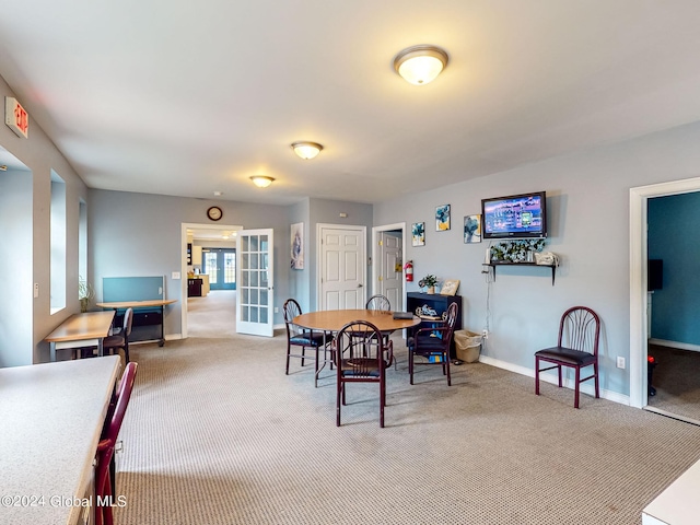 dining room with french doors and carpet flooring