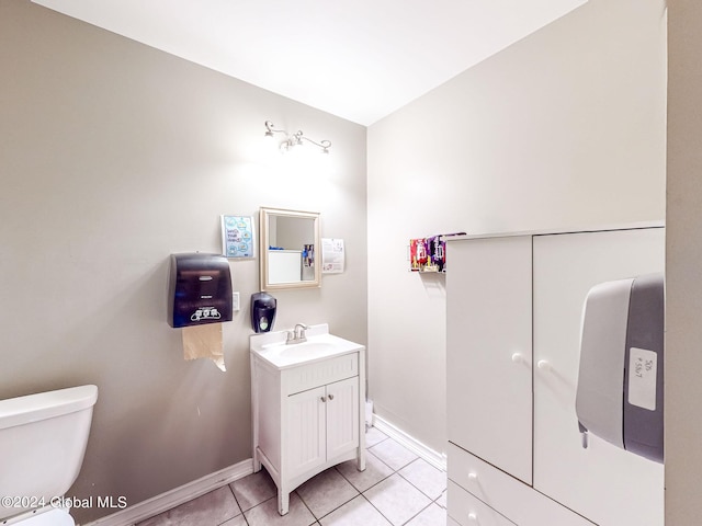 bathroom with vanity, tile patterned flooring, and toilet