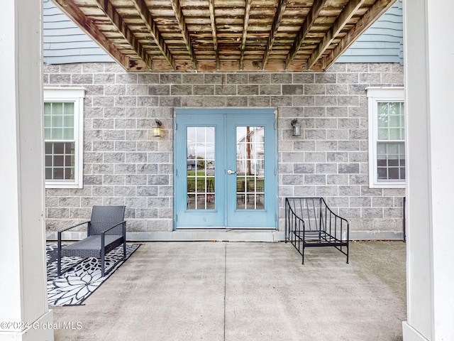 property entrance with french doors and a patio area