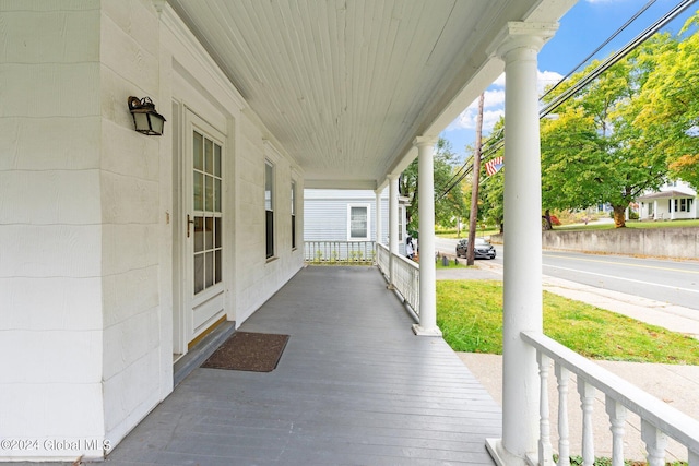 wooden terrace featuring covered porch