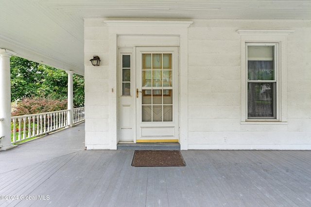 view of exterior entry featuring a porch