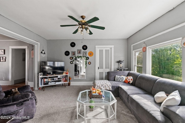 living room with ceiling fan and carpet flooring