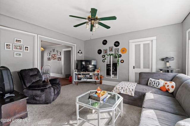 living room featuring ceiling fan and carpet floors