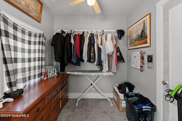 walk in closet with carpet floors and ceiling fan