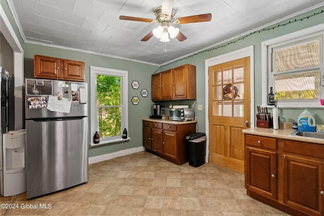 kitchen with ceiling fan, stainless steel refrigerator, and ornamental molding