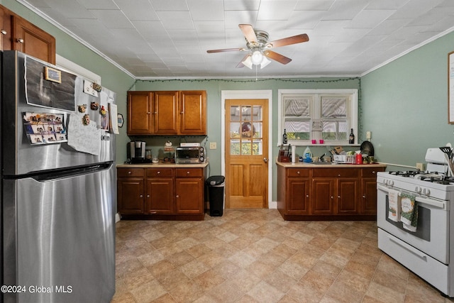 kitchen featuring stainless steel fridge, crown molding, ceiling fan, and white range with gas stovetop