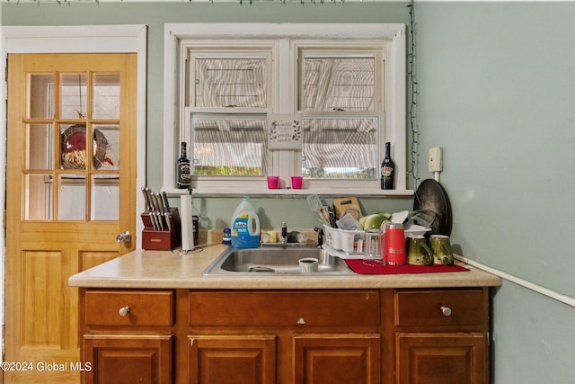 bar featuring a wealth of natural light and sink