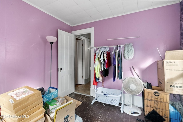 bedroom with crown molding and dark hardwood / wood-style flooring