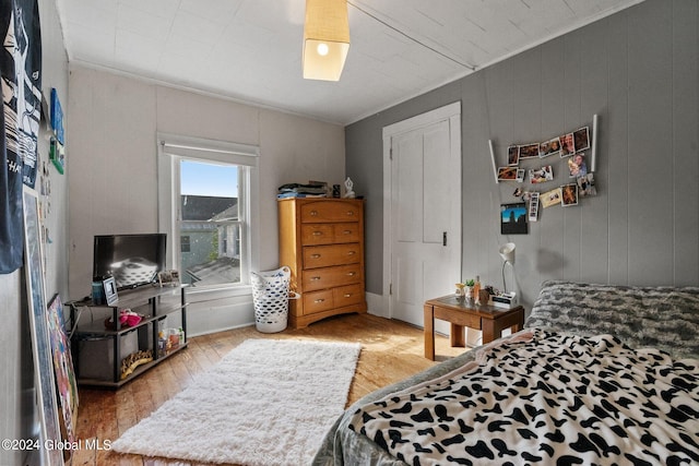 bedroom featuring hardwood / wood-style flooring and crown molding