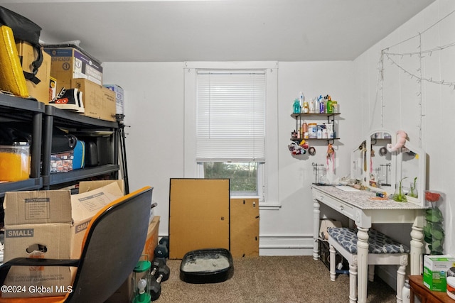 carpeted office space with baseboard heating