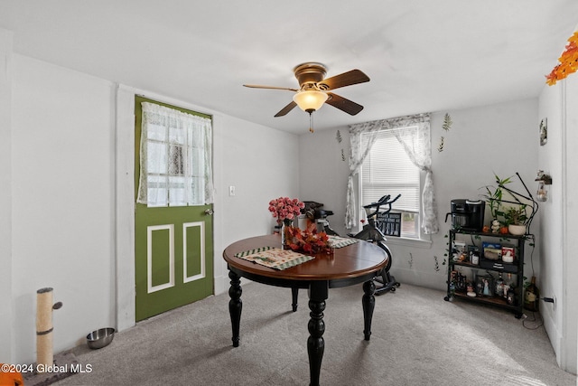 carpeted dining area featuring ceiling fan