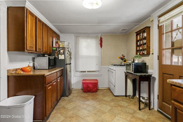 kitchen with appliances with stainless steel finishes and ornamental molding