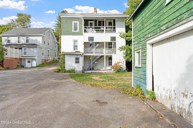 rear view of property featuring a balcony