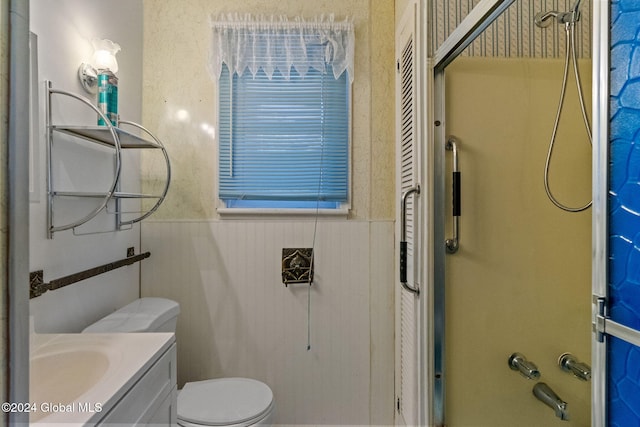 bathroom featuring toilet, vanity, and a shower