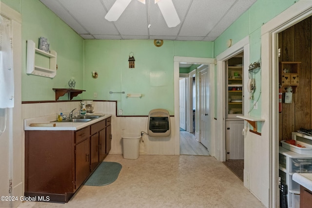 kitchen featuring a paneled ceiling, heating unit, sink, and ceiling fan