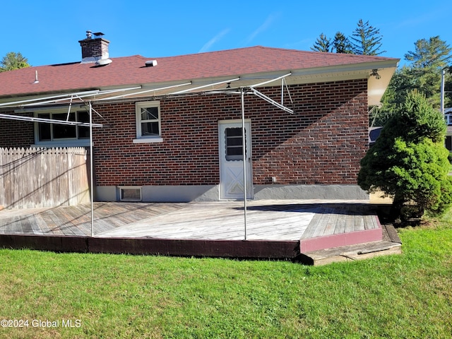 back of house with a lawn and a wooden deck