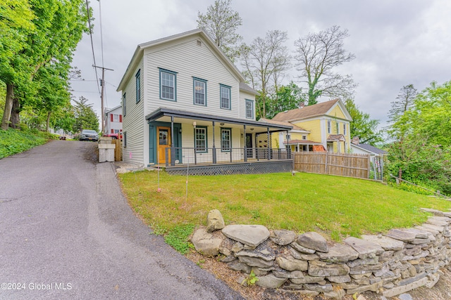 view of front of home featuring a front yard and a porch