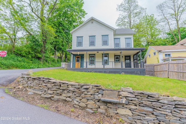 view of front of property with covered porch and a front yard