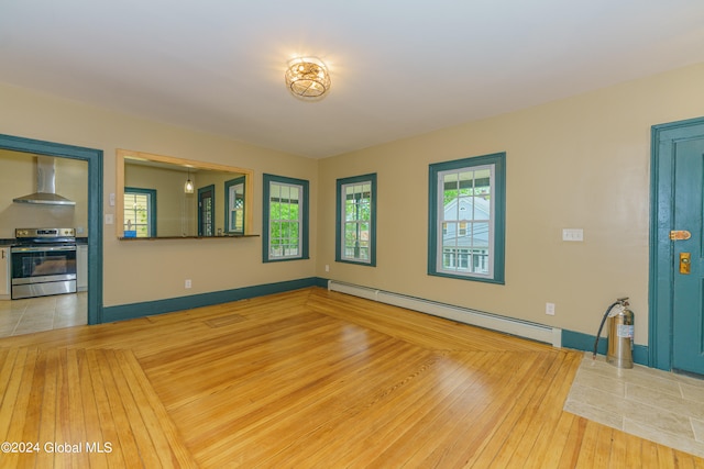 unfurnished living room with hardwood / wood-style flooring and baseboard heating