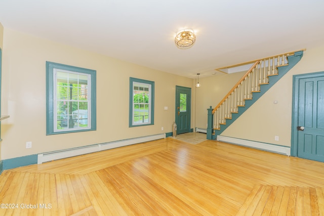 interior space featuring a baseboard heating unit and wood-type flooring