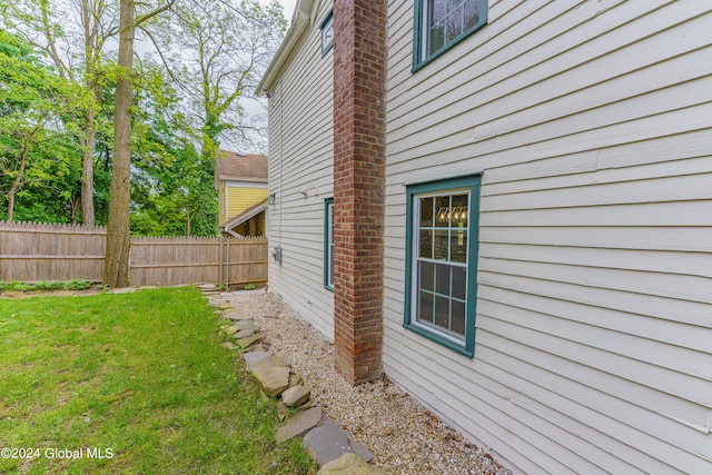 view of side of home featuring a lawn