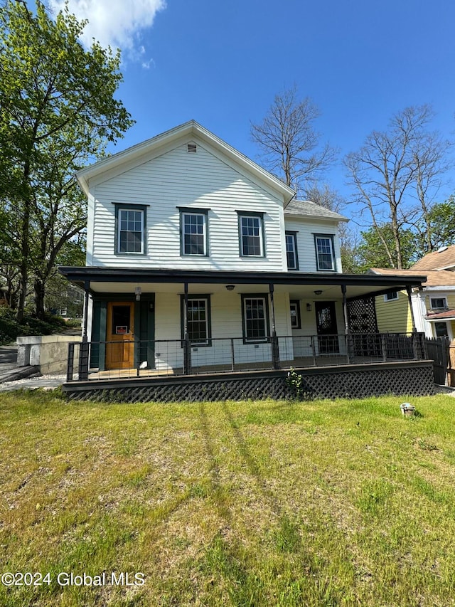 farmhouse with a porch and a front lawn