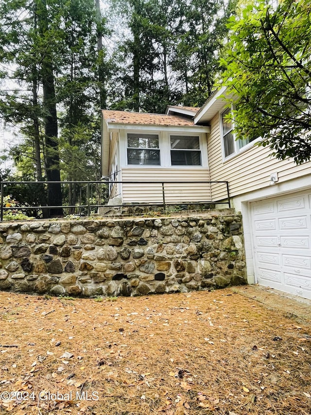 21 Pine Rd, Lake Luzerne, NY 12846 - view of side of home with fence and a garage