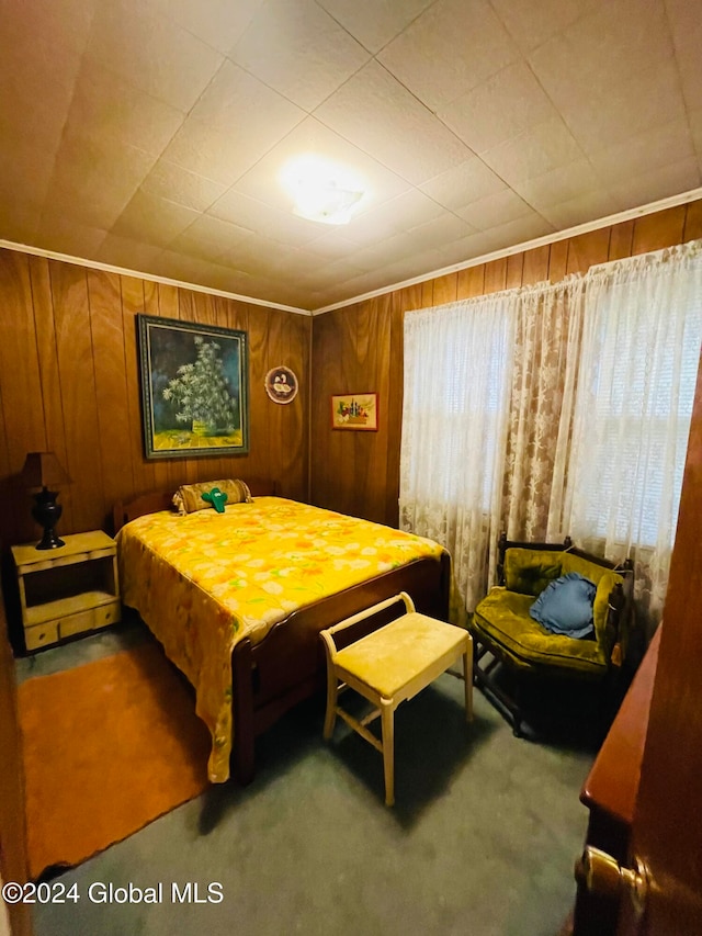 carpeted bedroom with wooden walls