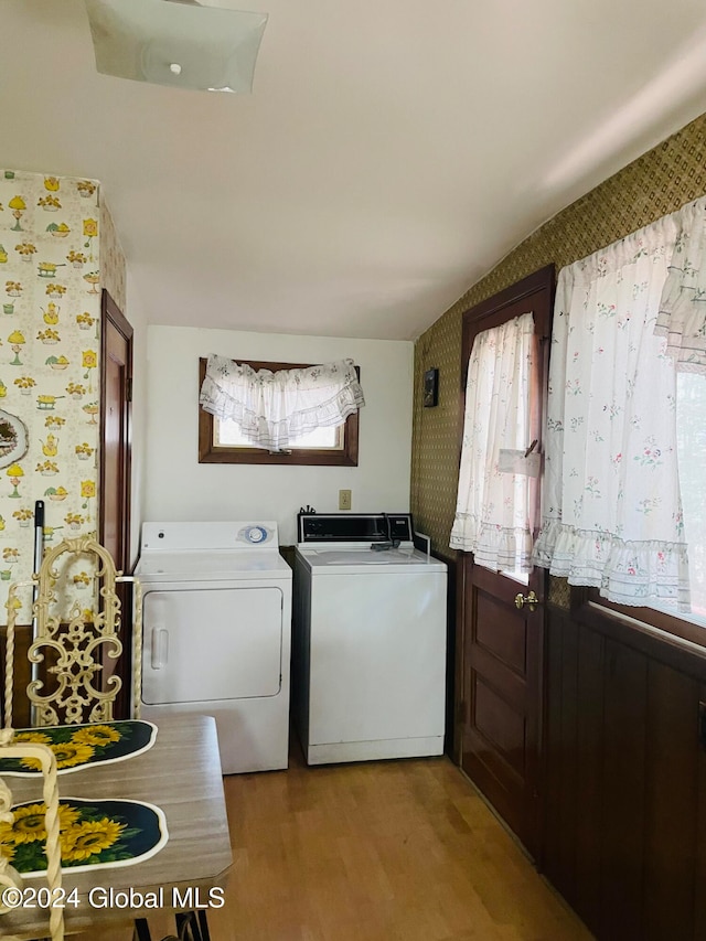 laundry area featuring light hardwood / wood-style floors and washing machine and dryer