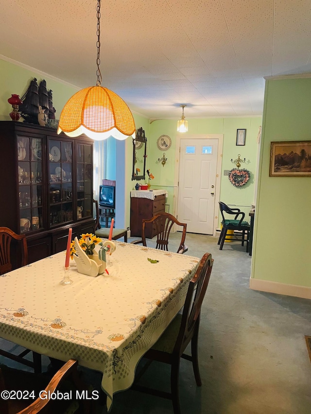 dining space featuring concrete flooring