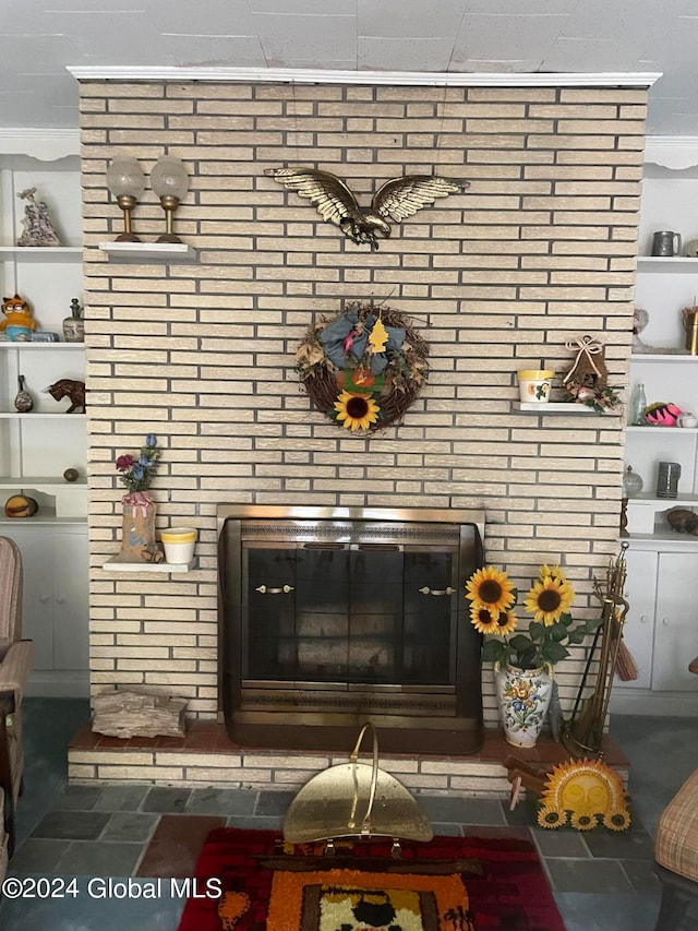 interior details featuring a fireplace and ornamental molding