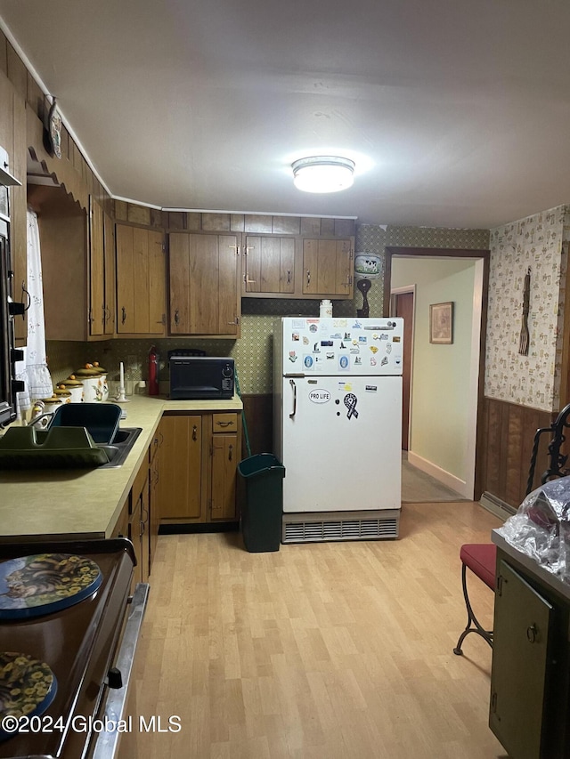 21 Pine Rd, Lake Luzerne, NY 12846 - kitchen featuring wallpapered walls, stainless steel electric stove, light wood finished floors, light countertops, and freestanding refrigerator