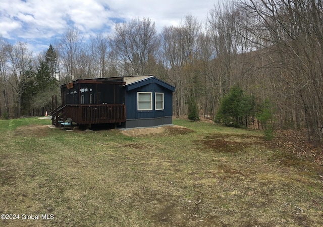 view of side of home with a yard