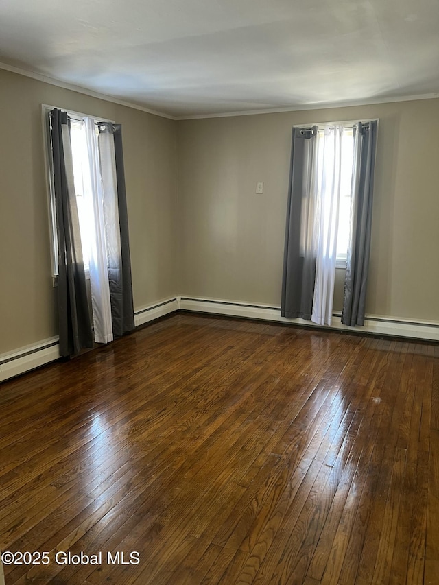 spare room featuring a wealth of natural light and dark hardwood / wood-style floors