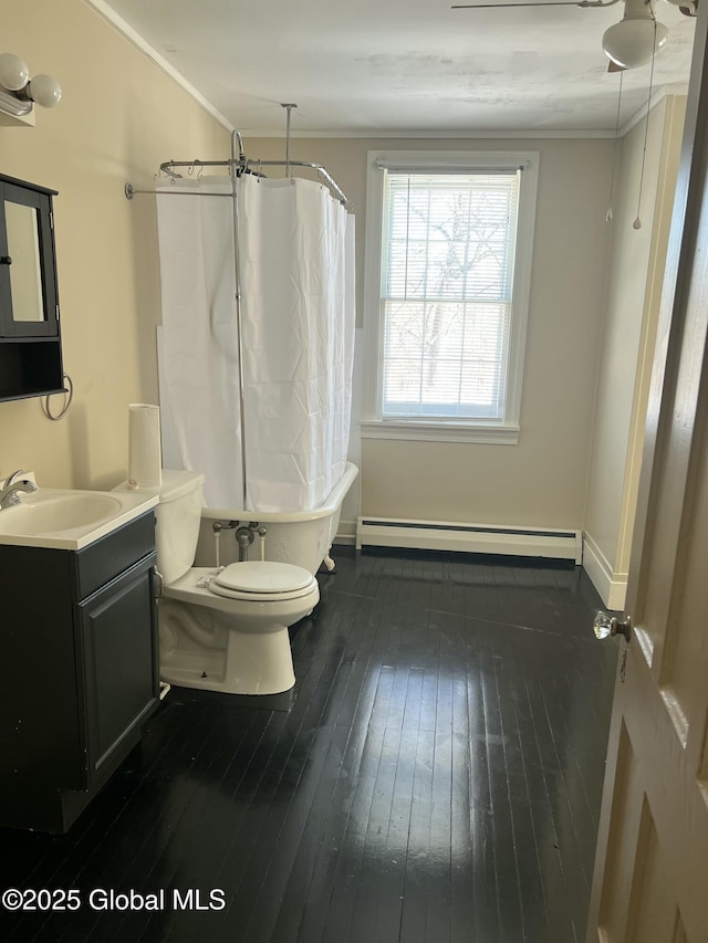 full bathroom featuring ornamental molding, toilet, shower / bath combination with curtain, and a baseboard heating unit