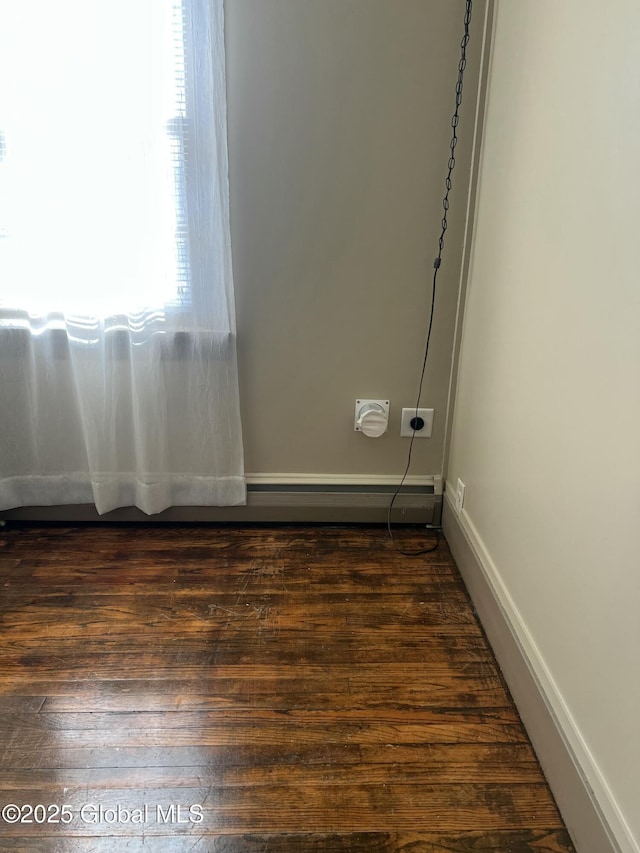 spare room with dark hardwood / wood-style flooring