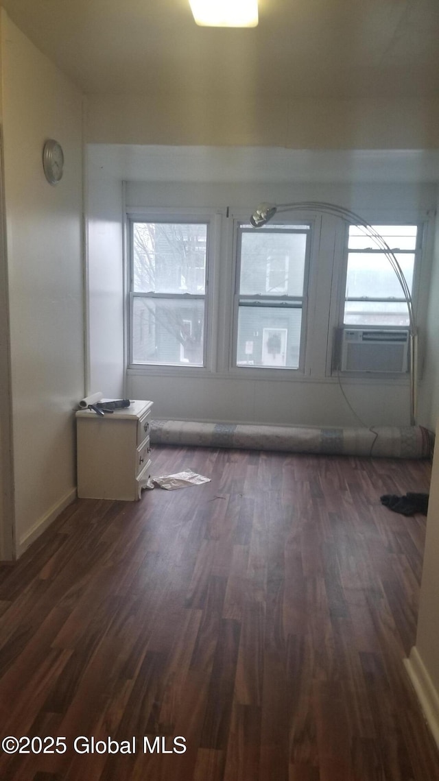 interior space featuring a wealth of natural light, dark hardwood / wood-style flooring, and cooling unit