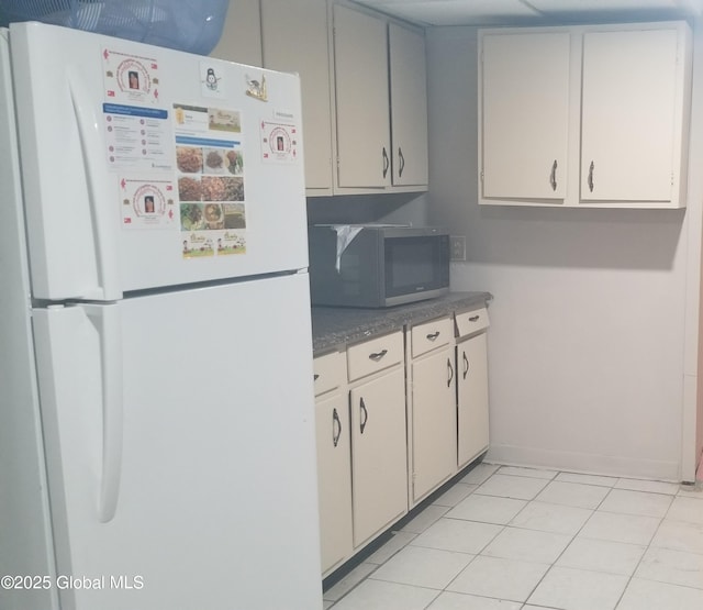 kitchen featuring white appliances and light tile patterned floors