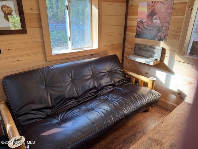 living room with wooden walls and wood-type flooring