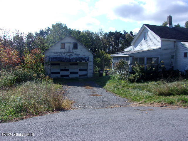 view of home's exterior with a garage and an outdoor structure