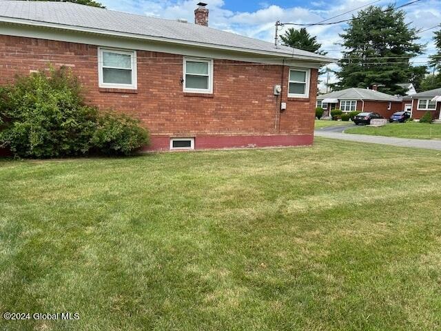 view of home's exterior featuring a lawn