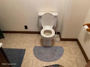 bathroom featuring toilet and tile patterned flooring